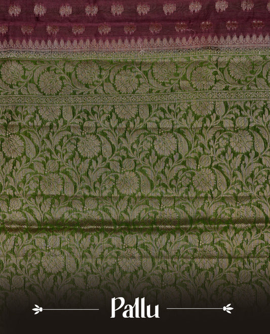 Brown colour Banaras silk saree featuring gold zari buttas on body, complemented by contrast Green colour border, comes with matching blouse piece.