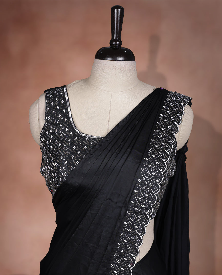 Elegant Black colour ready to wear saree adorned with rich white stone embroidery along the border and pallu, paired with a heavily embellished matching blouse for a grand festive look.