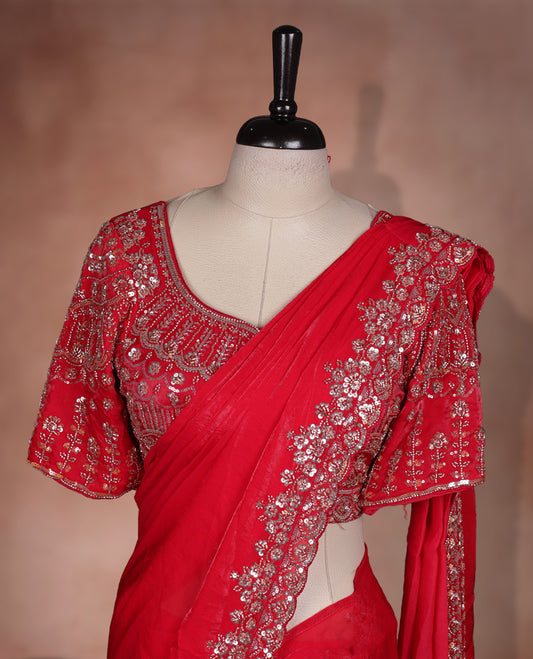 Elegant Red colour ready to wear saree adorned with rich Gold bead embroidery along the border and pallu, paired with a heavily embellished matching blouse for a grand festive look.