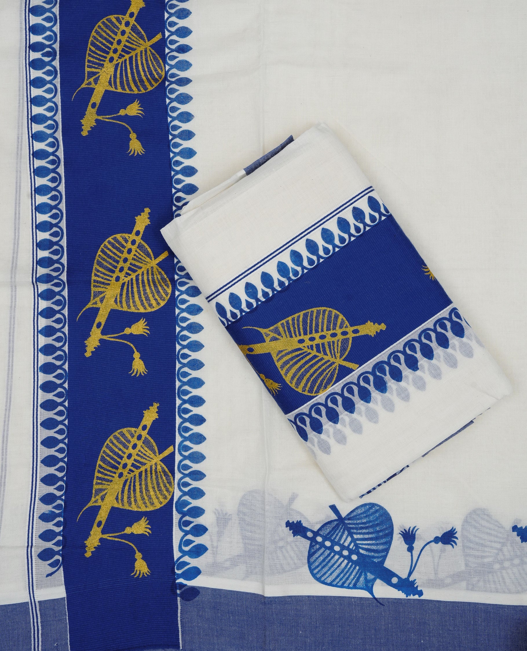 Cream colour cotton set mundu featuring Blue kara with Gold Leaf with flute print.
