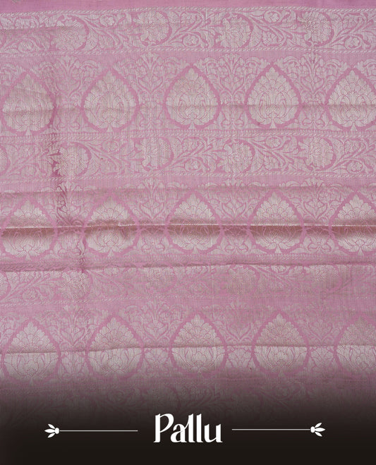 Light pink colour banaras saree featuring silver zari buttas on body, complemented silver zari on self colour border, comes with matching blouse piece.
