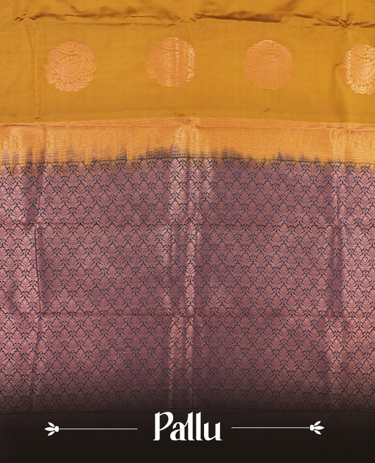 Dark mustard colour Semi Silk Saree with copper zari motifs on the body, paired with a contrast Dark blue colour pallu with copper zari traditioal border, and a matching blouse piece.