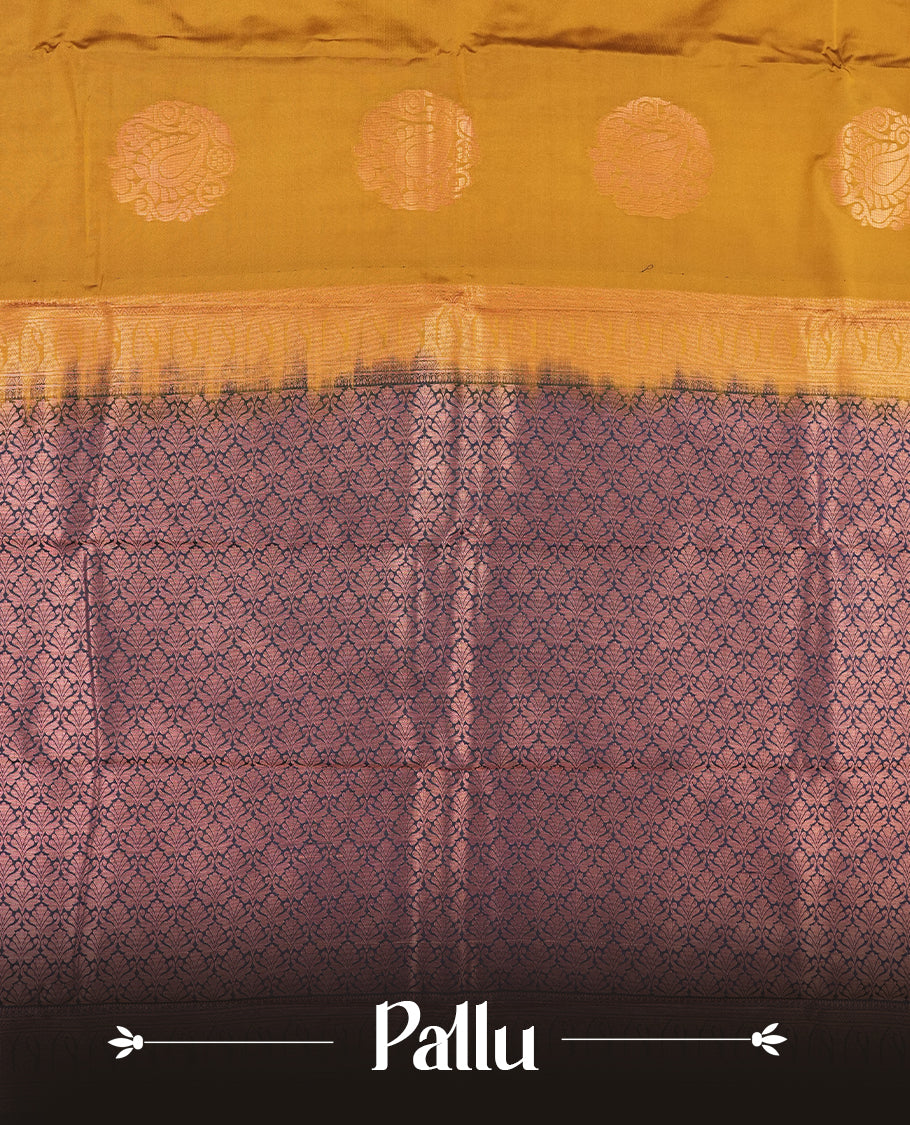 Dark mustard colour Semi Silk Saree with copper zari motifs on the body, paired with a contrast Dark blue colour pallu with copper zari traditioal border, and a matching blouse piece.