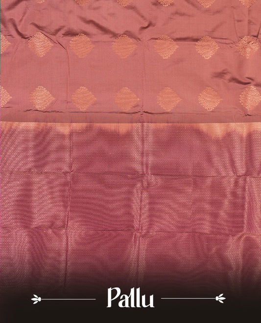 Dusty Rose colour Semi Silk Saree with copper zari motifs on the body, paired with a contrast Dark purple colour pallu with copper zari traditioal border, and a matching blouse piece.