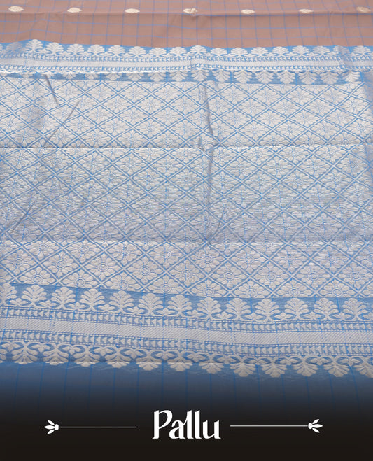 Beige Colour silk cotton saree with checkered body, scattered silver zari leaf buttas, ornate silver zari borders in teal green, diamond lattice pallu with temple motifs, teal green blouse with matching border.