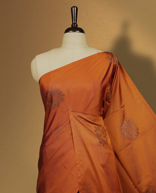 Brown colour semi soft silk saree featuring intricate woven floral motifs on the body, complemented by a rich woven border and pallu with tassel finish & Comes with a matching blouse piece for an elegant look.