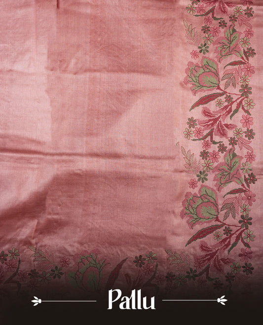 Pastel peach colour Pure tusser silk saree featuring finely crafted floral thread embroidery detailing on the border, pallu and with matching blouse piece.