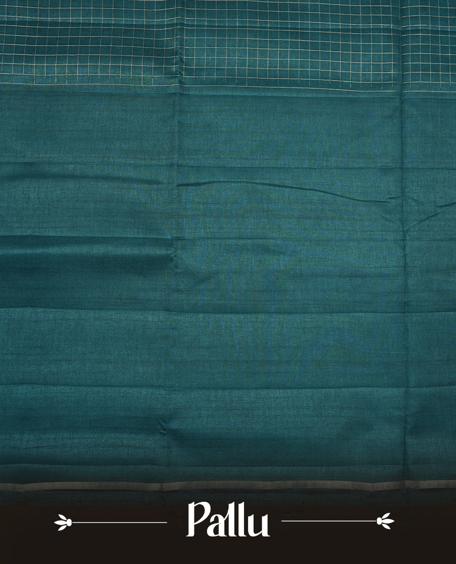 Teal colour semi Tussar saree highlights gold zari check pattern across body,  border, pallu and paired with matching blouse piece.