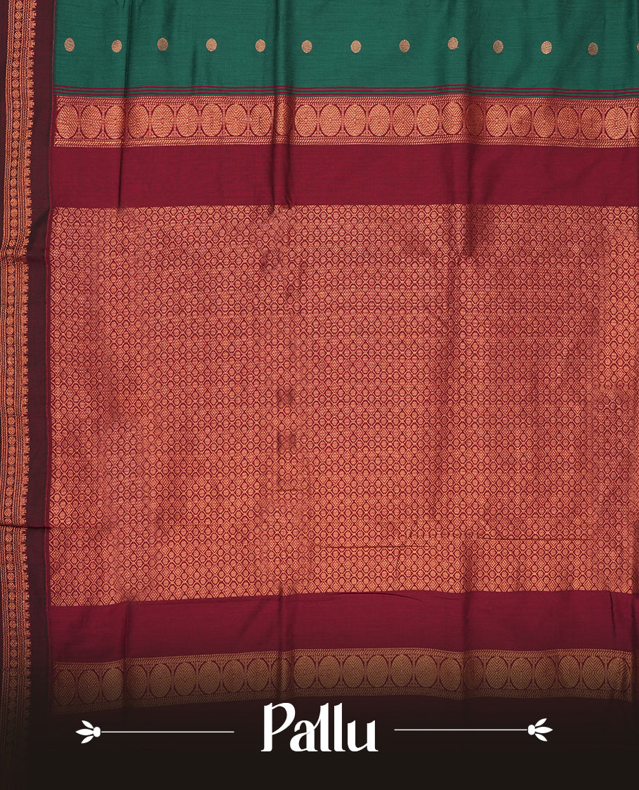 Teal green Kalyani cotton saree with contrast maroon border highlighted by rich golden zari weaving and elegant buttas on the body & Comes with blouse.