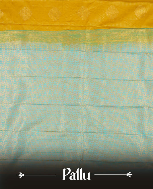 Yellow Semi Silk Saree featuring gold zari motifs on the body, contrasted with a light blue and gold zari pallu and border adorned with traditional motifs, paired with a matching blouse piece.
