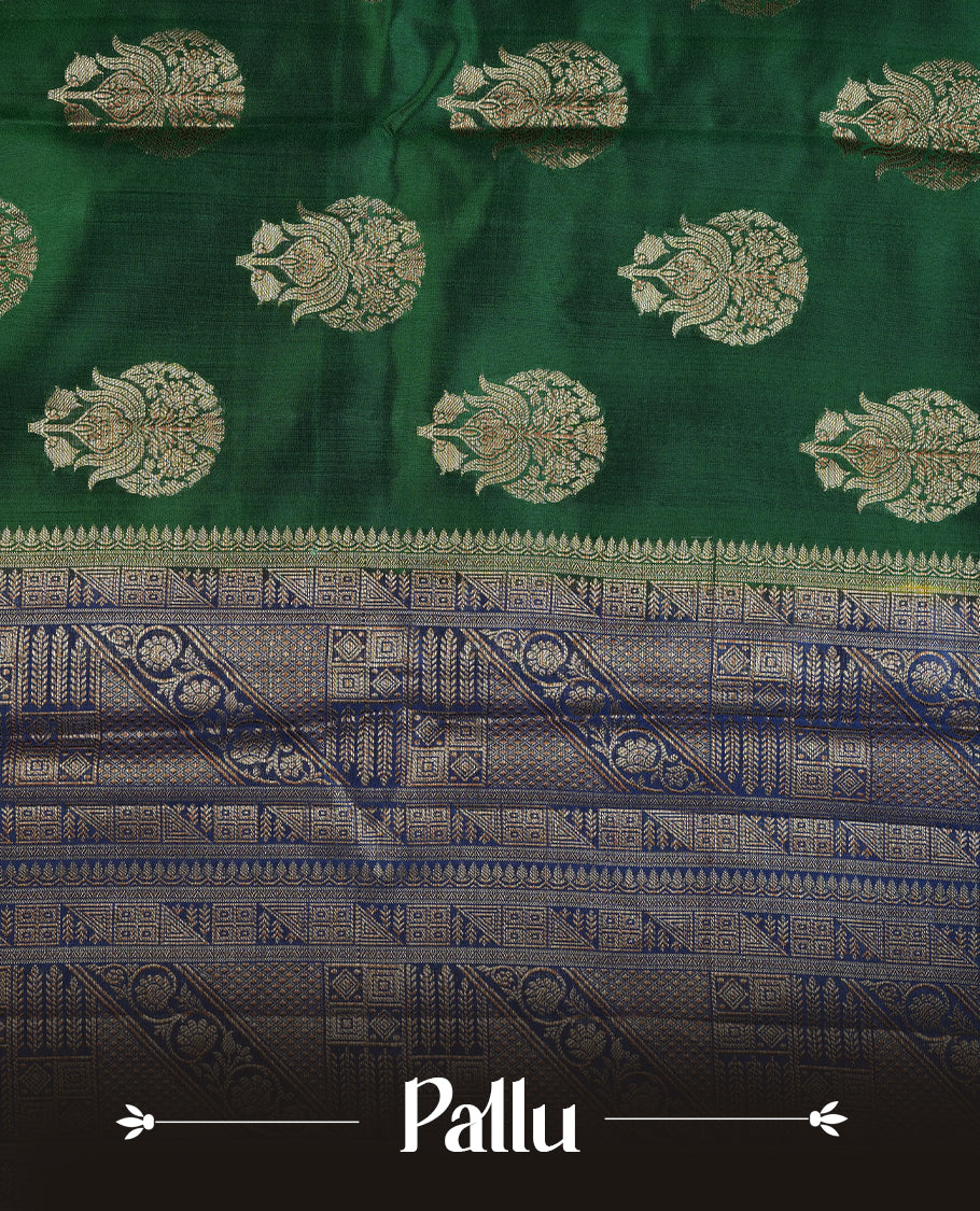Dark green colour Pure tussar Banarasi saree featuring Gold zari motifs on body, a contrast navy blue colour gold zari border, and a matching blouse piece.