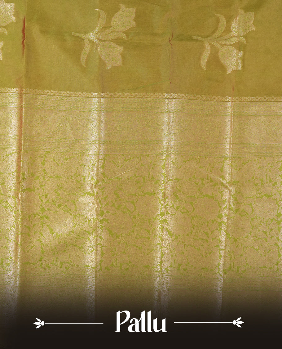 Olive Green colour semi silk saree adorned with floral motifs on the body, complemented by a shimmering golden zari-woven pallu and border, and paired with a matching blouse