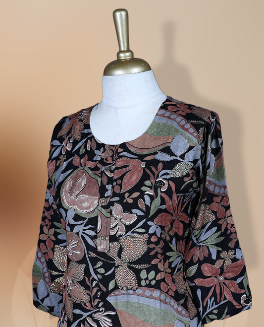 Black colour kurti featuring a round neckline, 3/4th flared sleeves, and an all over floral print in green and beige hues, designed with a straight cut silhouette for a chic casual look.