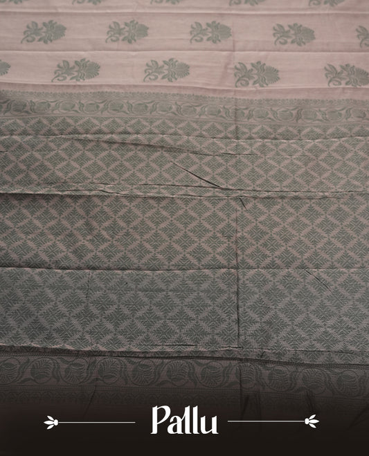 Dusty grey colour silk cotton saree featuring elegant floral zari motifs on the body, complemented by a rich contrast dark greenish border and pallu with traditional woven detailing & Comes with a matching blouse piece.