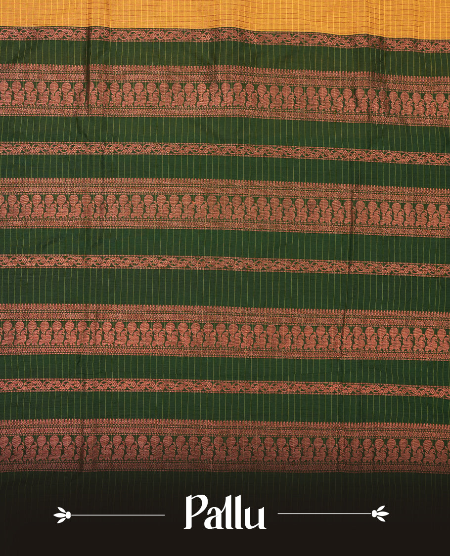 Mustard yellow coloured mixed Kalyani cotton saree featuring copper zari checks on the body, complemented by a dark green coloured border and pallu adorned with copper zari patterns, Paired with a matching blouse.