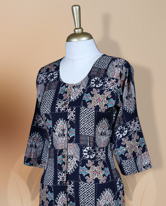 Navy blue colour kurthi adorned with delicate floral prints, featuring a round neckline and three quarter sleeves & Crafted for comfort and style, perfect for casual and semi formal occasions.