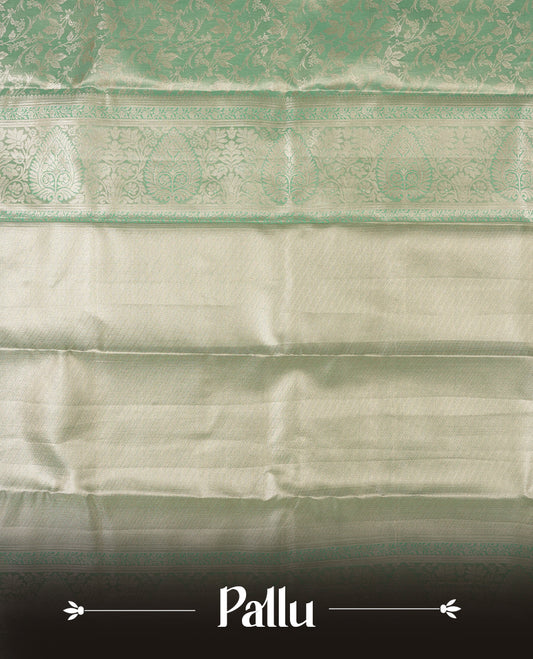 Light aqua green colour and gold Zari Tissue Brocade Saree features intricate floral Motifs on body and self coloured with traditional border & pallu, paired with matching blouse