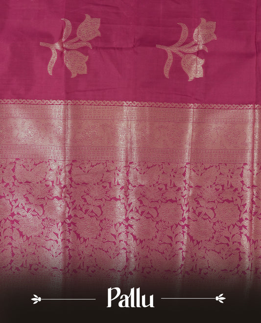 Burgundy colour semi silk saree adorned with elegant floral motifs on the body, complemented by a shimmering golden zari-woven pallu and border, and paired with a matching blouse