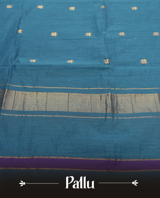 Teal Blue Colour silk cotton saree featuring small zari buttas on the body, contrast purple section, zari pallu, and matching blouse with border detailing.