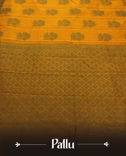 Mustard yellow colour silk cotton saree featuring elegant floral zari motifs on the body, complemented by a rich contrast dark green border and pallu with traditional woven detailing & Comes with a matching blouse piece.