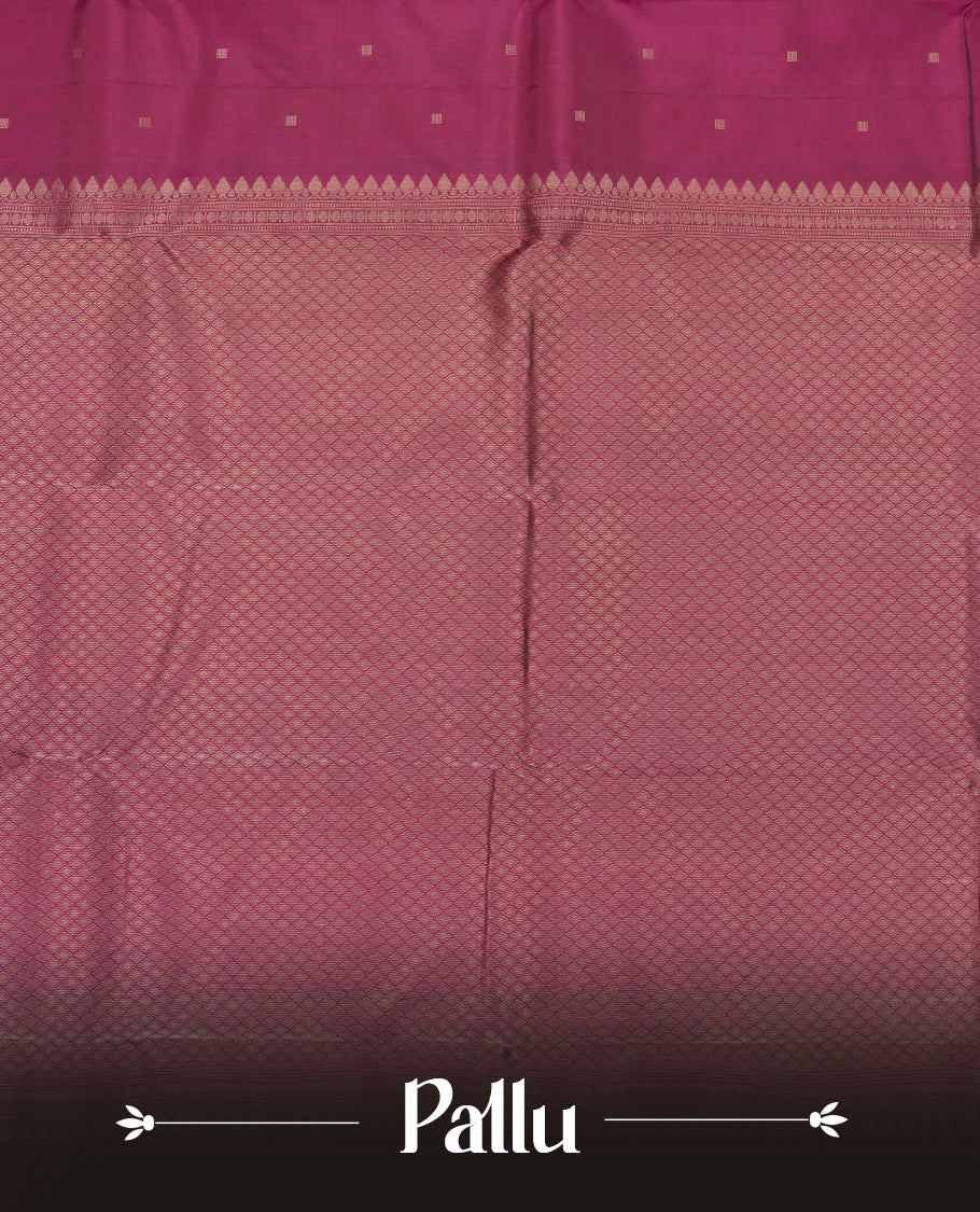 Deep violet colour Vasundhara silk saree adorned with all-over gold square motifs on the body, complemented by a Black & pink colour zigzag border and paired with a matching blouse piece.