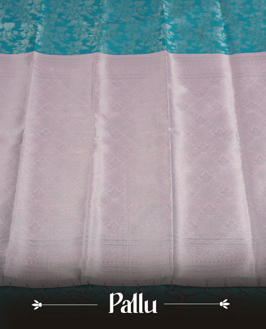 Aqua blue colour semi silk saree adorned with silver zari designs on the body, complemented by a contrasting Aqua blue border and pallu, and paired with a matching blouse piece