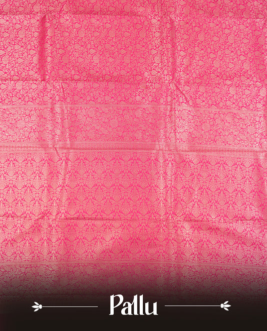 Rani pink colour semi silk brocade saree featuring intricate Gold Floral kodi patterns across the body, complemented by a rich self colour woven border and pallu, paired with a matching blouse.