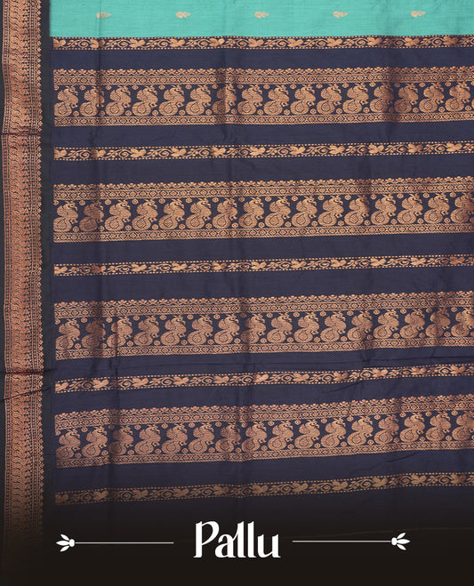 Sky blue colour Kalyani cotton saree with subtle zari motifs all over, paired with a contrasting rich navy blue copper peacock zari woven border and pallu & comes with a matching blouse piece.