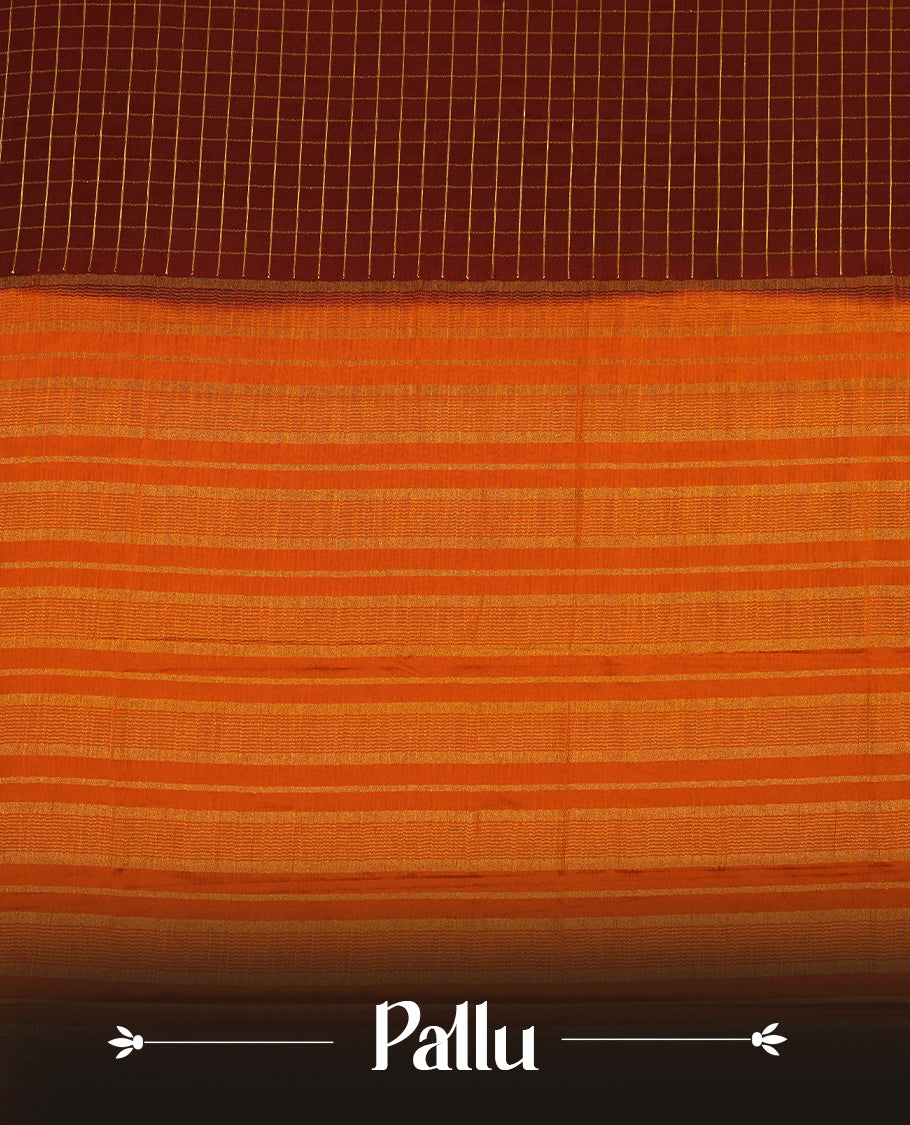 Dark Choclate colour mysore crepe saree with gold zari check pattern on body, complemented by contrast dark mustard colour border featuring peacock and chakkram motifs, paired with matching blouse.