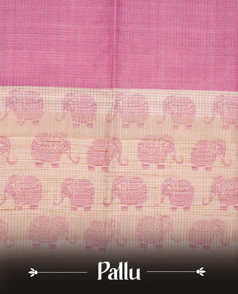Pink colour semi tussar silk saree featuring an all-over elephant motif print across the body, complemented by a contrasting yellow pallu and border, and paired with a matching blouse piece.