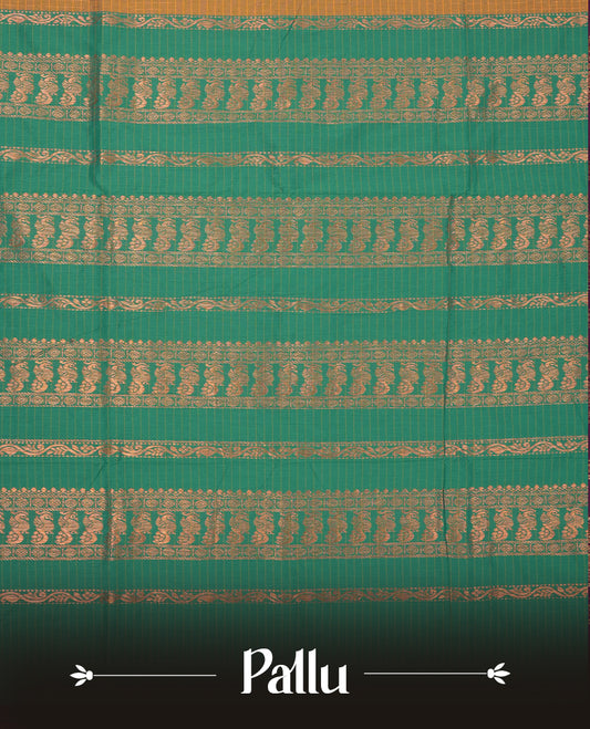 Mustard yellow coloured mixed Kalyani cotton saree featuring copper zari checks on the body, complemented by a dusty green coloured border and pallu adorned with copper zari patterns, Paired with a matching blouse.