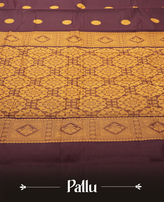 Dark Brown colour Silk Cotton Saree with Mustard Orange Circular Buttas on the Body, Contrasting Antique Gold Zari Pallu Featuring Intricate Floral and Geometric Motifs with Temple-Style Borders, Paired with a Coordinated Blouse Piece
