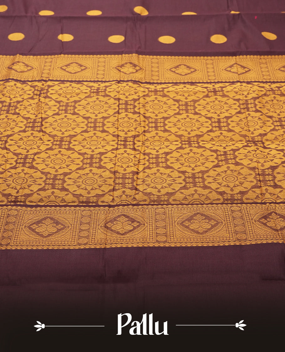 Dark Brown colour Silk Cotton Saree with Mustard Orange Circular Buttas on the Body, Contrasting Antique Gold Zari Pallu Featuring Intricate Floral and Geometric Motifs with Temple-Style Borders, Paired with a Coordinated Blouse Piece