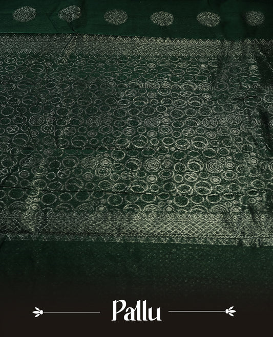 Dark green colour silk cotton saree with shimmering silver zari border and intricately woven pallu, blending elegance and tradition, Paired with a matching blouse, perfect for festive celebrations and special occasions.