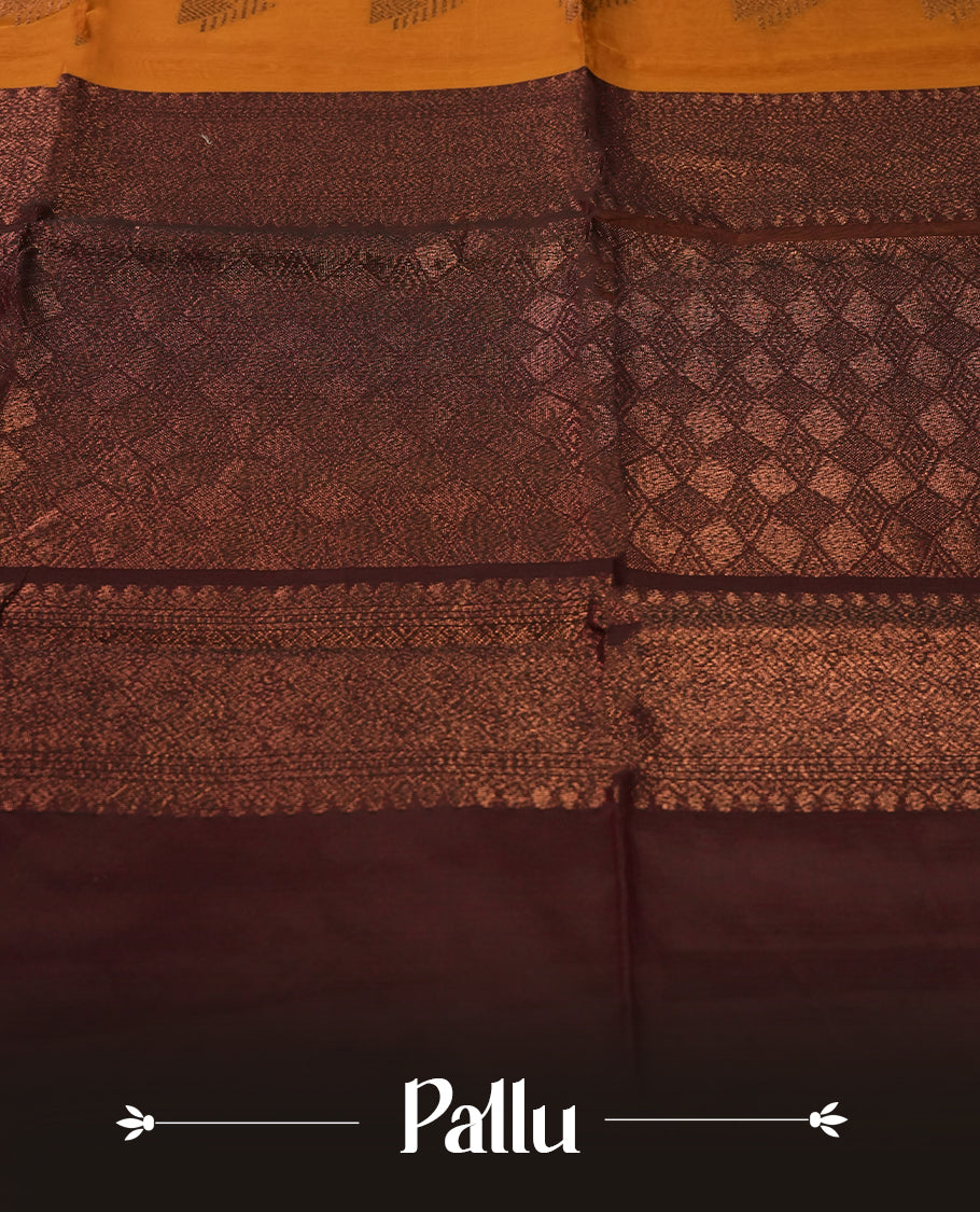 Mustard colour soft silk cotton saree adorned with copper zari motifs and a shimmering copper zari border, Enhanced by a beautifully rich brown colour woven pallu & Comes with a matching blouse piece for a complete look.