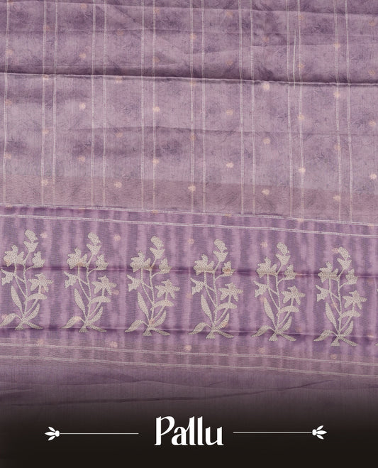 Light lavender colour semi tussar saree adorned with Cream strip printed pattern across the body, with cream Floral pattern on contrast Light purple colour border, paired with a matching blouse.