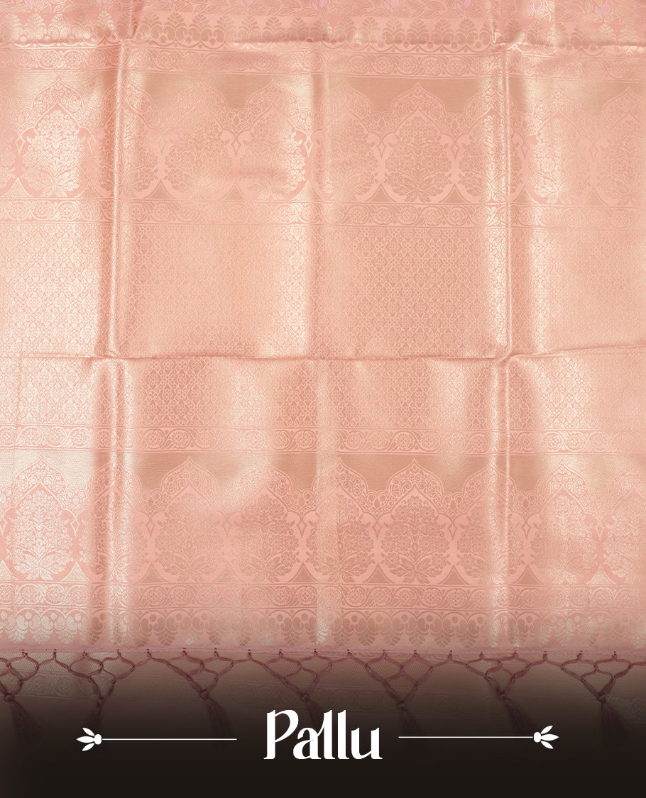 Peach colour semi soft silk saree featuring an all-over woven leaf pattern, finished with a matching pastel peach border adorned with detailed paisley and floral motifs, and a matching blouse piece.