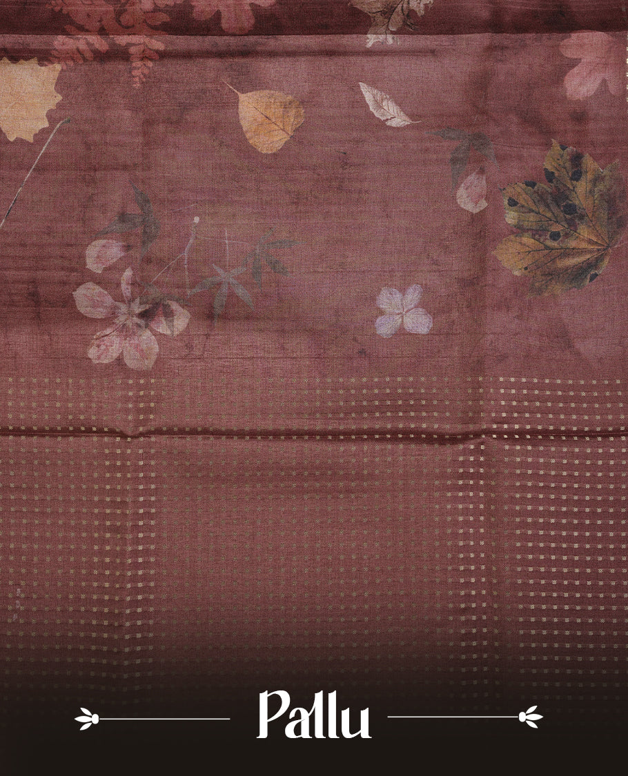 Brown colour tussar saree featuring woven Eco leaves printed on the body, complemented by a self colour gold zari bindi butta border & pallu, paired with a matching blouse.