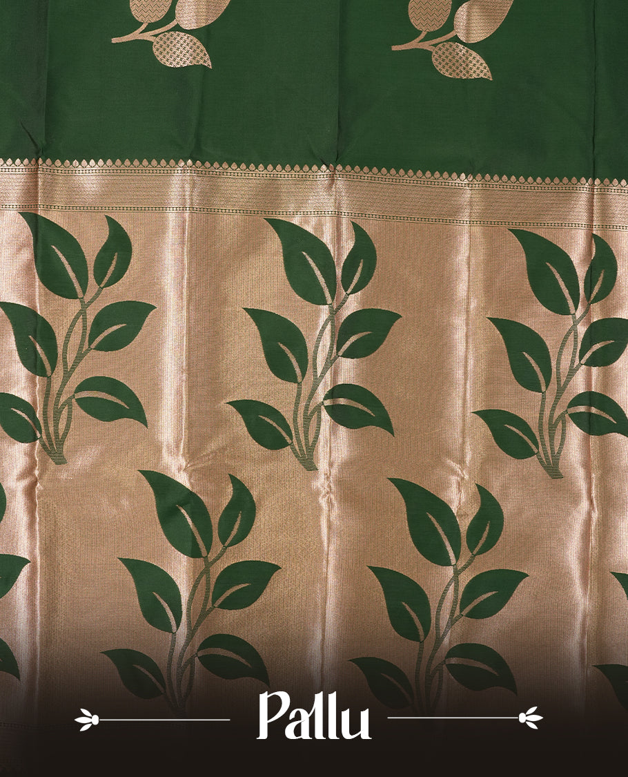 Dark green colour semi silk saree adorned with elegant floral motifs on the body, complemented by a shimmering golden zari-woven pallu and border, and paired with a matching blouse