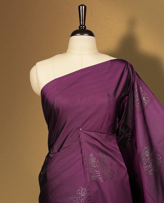 Grape colour semi soft silk saree, adorned with subtle self woven motifs on the body & The design is elevated with an elegant zari border and pallu, paired with a matching blouse.