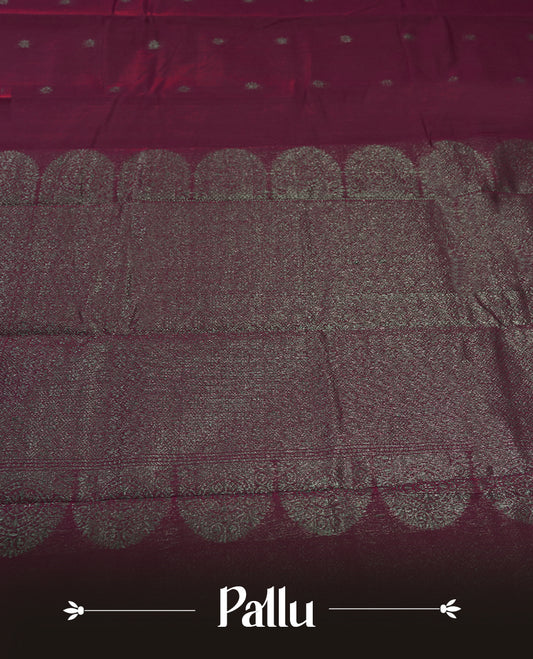 Magenta colour silk cotton saree adorned with a shimmering silver zari border and intricate woven designs, blending elegance with tradition, Paired with a matching blouse, its perfect for festive and special occasions.