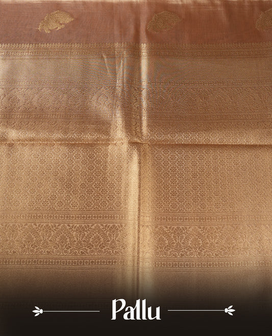 Gold colour tissue banaras silk saree featuring antique gold peacock zari motifs on the body with rich traditional zari border and pallu, paired with a matching blouse piece.