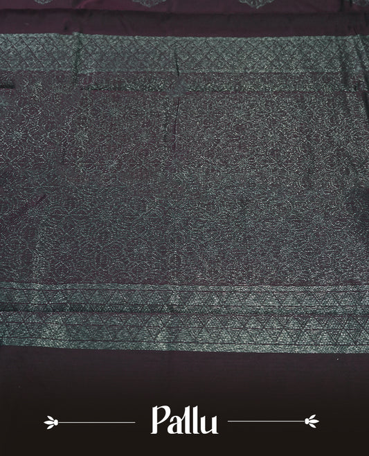 Wine colour silk cotton saree adorned with a shimmering silver zari border and intricate woven designs, blending elegance with tradition, Paired with a matching blouse, its perfect for festive and special occasions.