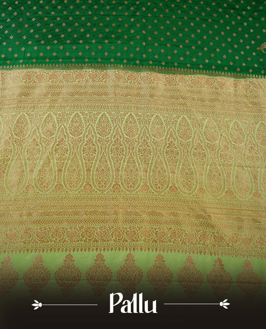 Dark Green colour pure Banarasi georgette saree featuring gold zari Flower Motifs all over the body, complemented by an contrast Light green dye colour with gold zari Floral Kodi Worked border and pallu, with matching blouse.