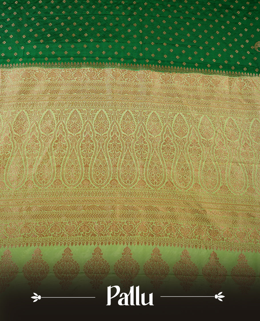 Dark Green colour pure Banarasi georgette saree featuring gold zari Flower Motifs all over the body, complemented by an contrast Light green dye colour with gold zari Floral Kodi Worked border and pallu, with matching blouse.