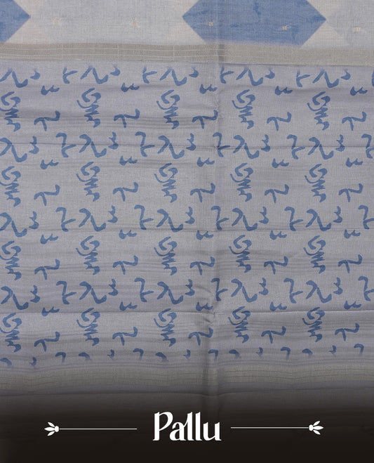 Steel blue colour semi tusser silk saree featuring geometric print pattern across body, gold zari border with style motifs and paired with matching blouse.