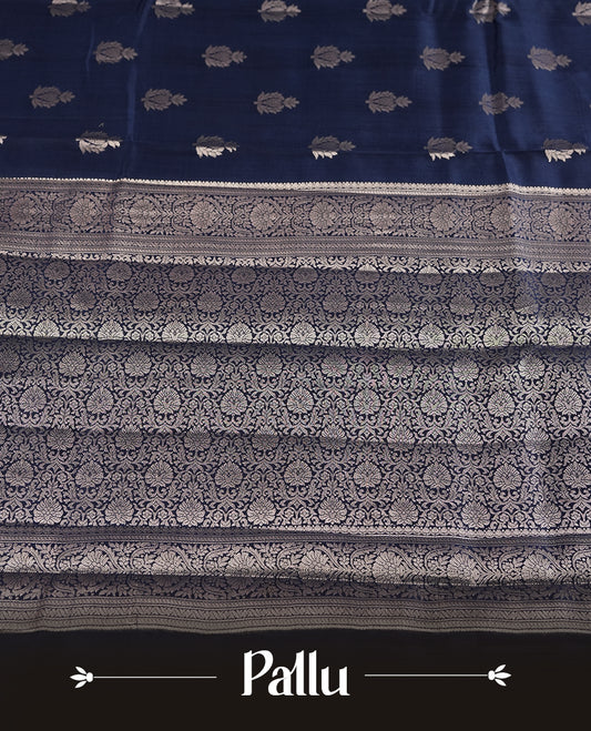 Pastel navy blue colour pure banarasi tussar soft silk saree adorned with delicate silver motifs all over the body, complemented by an intricate Banarasi style silver zari border & Comes with a matching blouse piece.