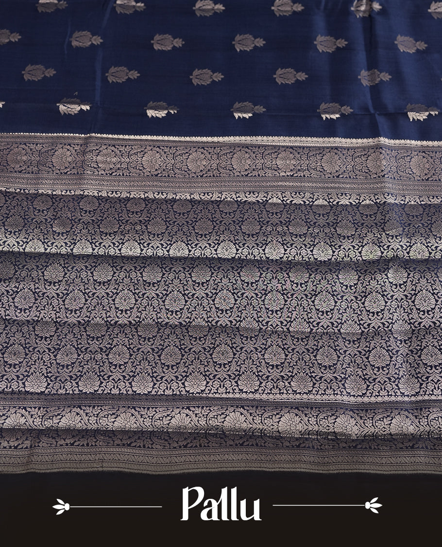 Pastel navy blue colour pure banarasi tussar soft silk saree adorned with delicate silver motifs all over the body, complemented by an intricate Banarasi style silver zari border & Comes with a matching blouse piece.