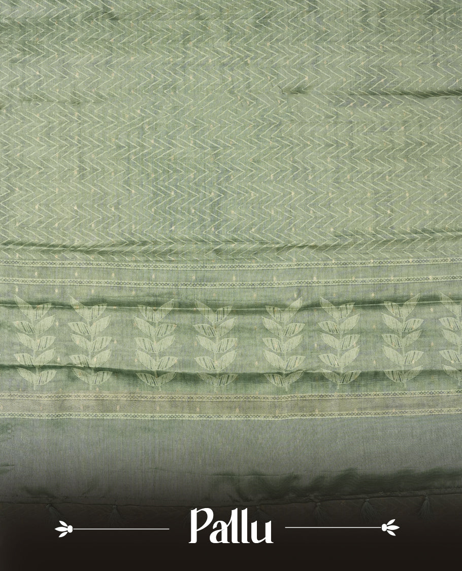 Sage green colour semi tussar saree adorned with Cream Zigzag printed pattern across the body and Leaf pattern on contrast Fern green colour border, paired with a matching blouse.