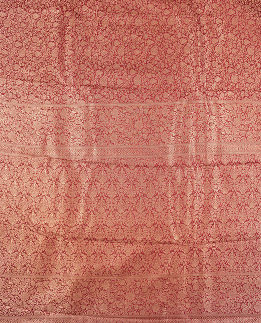 Deep Brown colour semi silk brocade saree featuring intricate Gold Floral kodi patterns across the body, complemented by a rich self colour woven border and pallu, paired with a matching blouse.